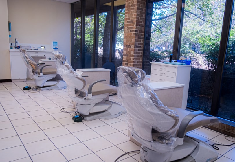 Oral surgery room with three chairs and a beautiful view of the outside from the window